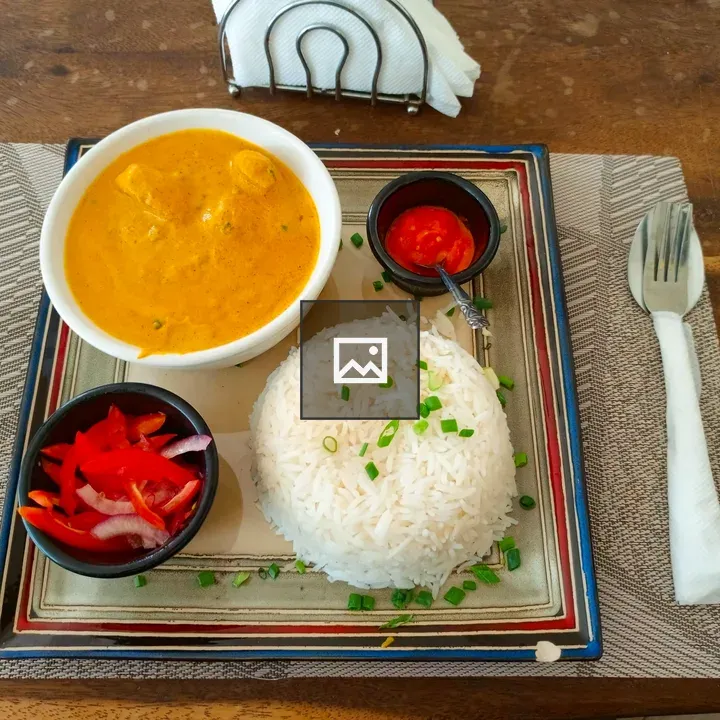 Butter chicken with rice and sides