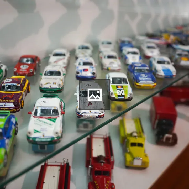 Glass display case with model race cars