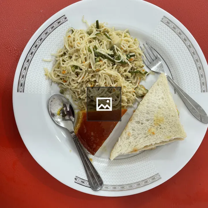 Breakfast plate with noodles and sandwich