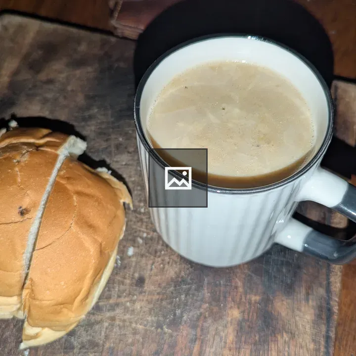 Milk and buttered bread on board
