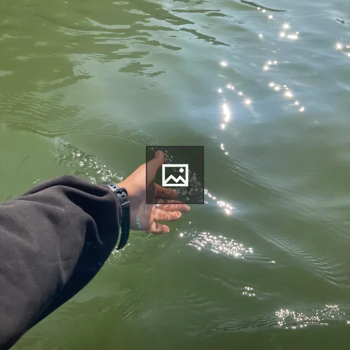 Hand Reaching Toward Water
