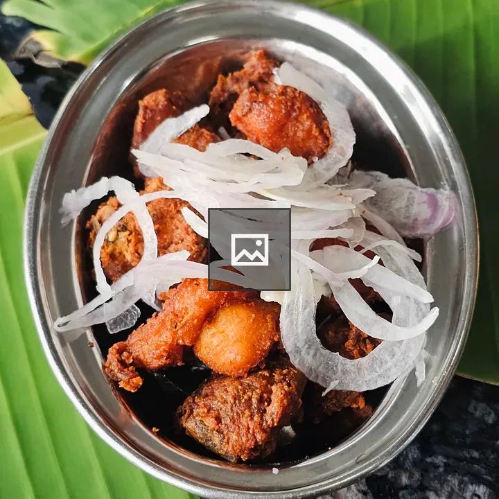 Bowl of Spicy Fried Chicken on Banana Leaf