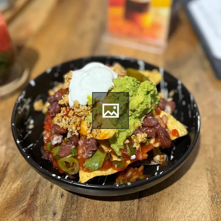 Loaded nachos in black bowl