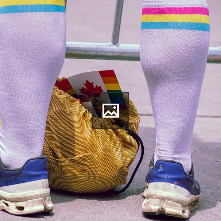 Person with rainbow socks and flag bag