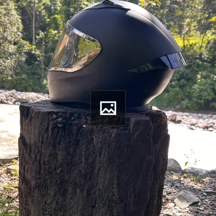 Helmet on Tree Stump by River