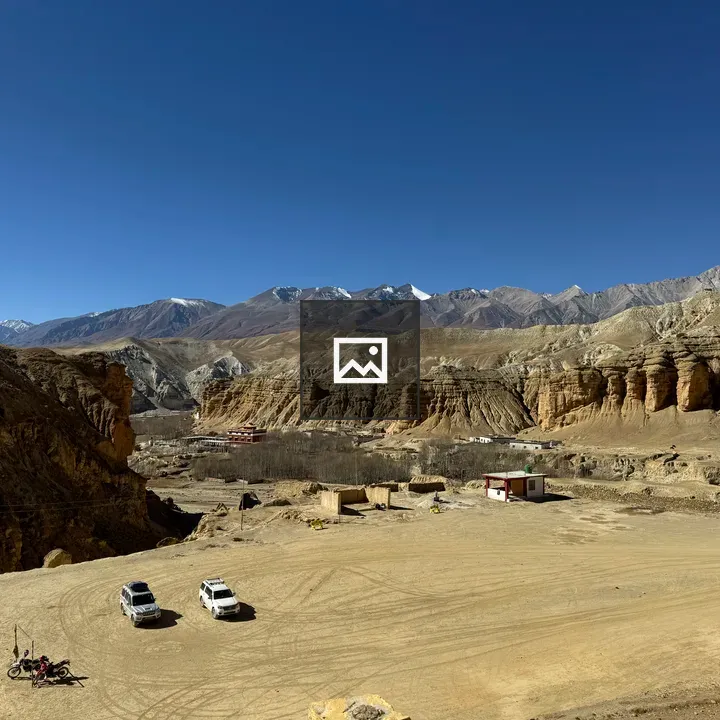 Desert mountain landscape with two white off-road vehicles