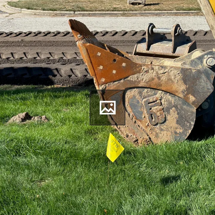 Bucket on Grass with Backhoe