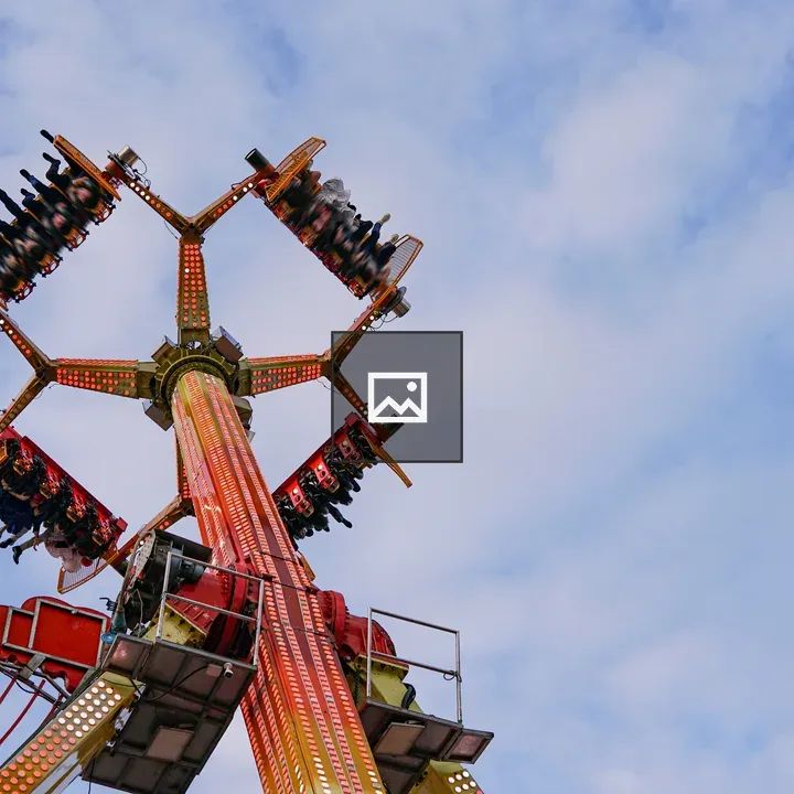 Tall amusement ride viewed upward