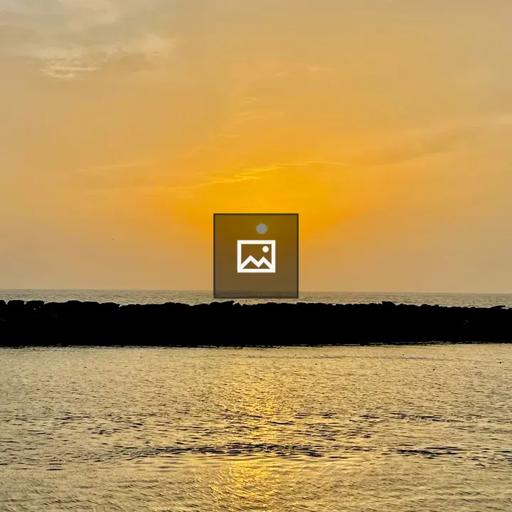 Sunset over rocks and water