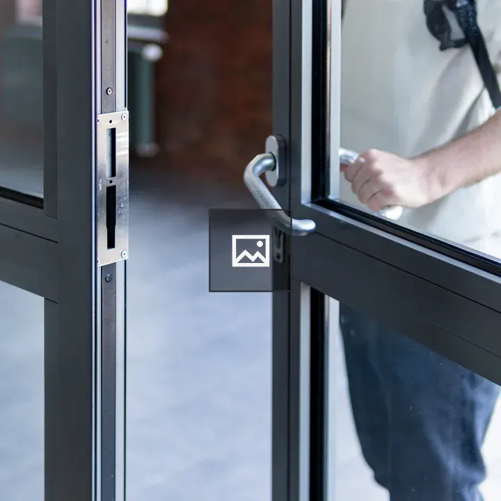 Man opening glass doors