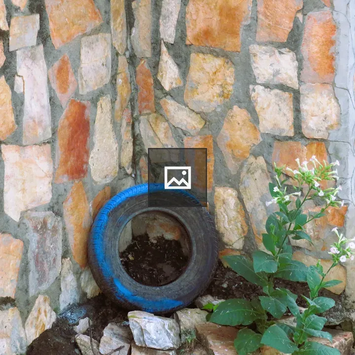 Tire Against Stone Wall