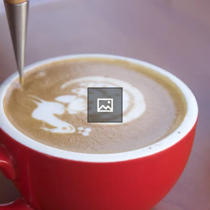 Red cup of cappuccino with latte art