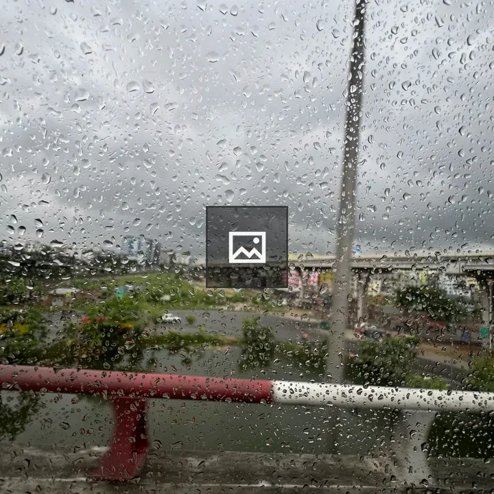 Rainy cityscape through window