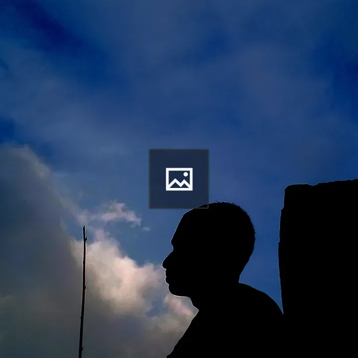 Boy by a Pillar Under Night Sky