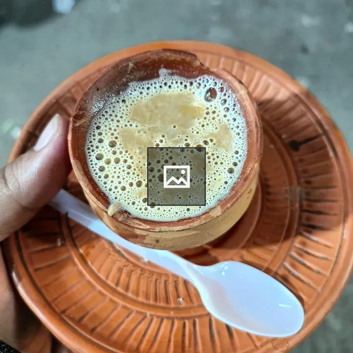 Hand holding clay teacup