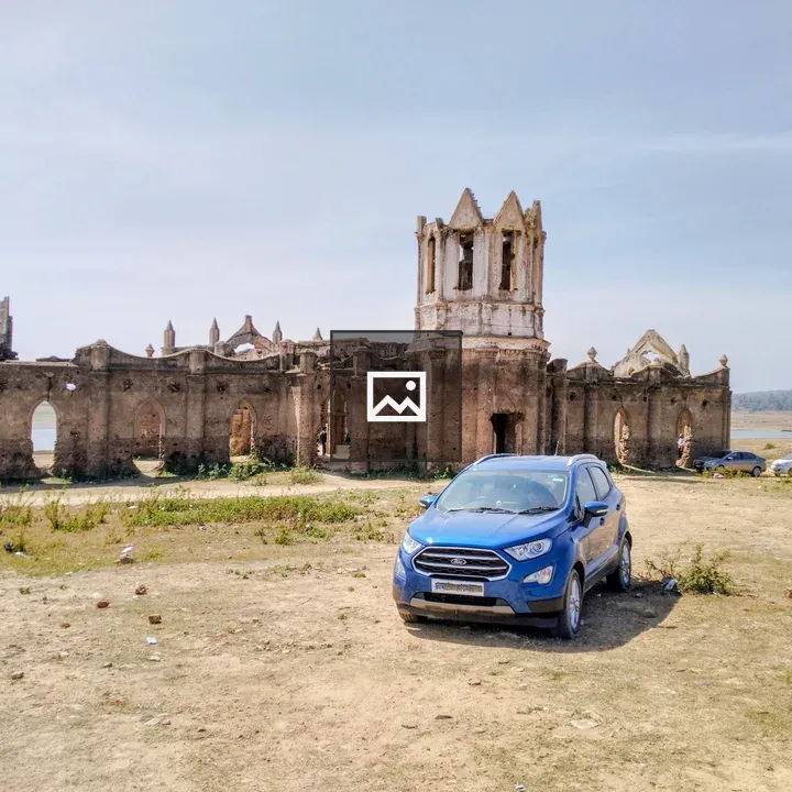 Blue SUV in front of church