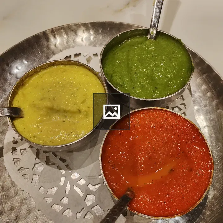 Three chutney bowls on tray