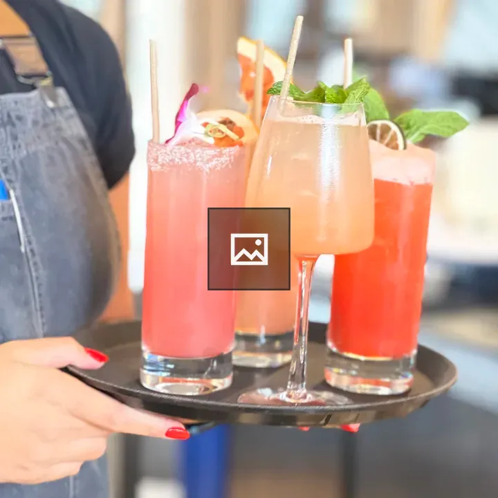 Four fruity cocktails on a tray