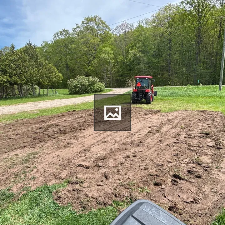 Green Lawn with Dirt Patch and Tractor