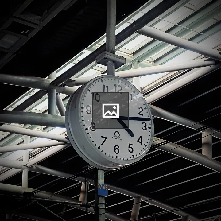 Clock on metal beam at station