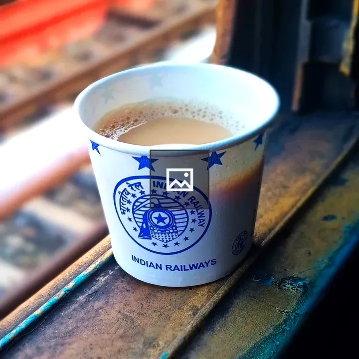 Cup of coffee by window on train