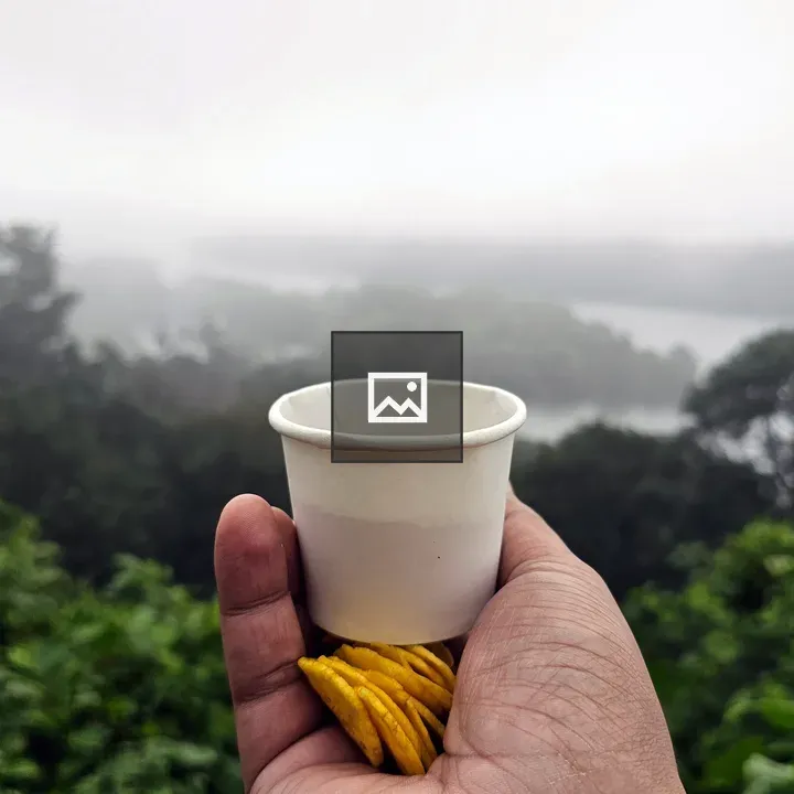 Hand with Coffee and Banana Chips