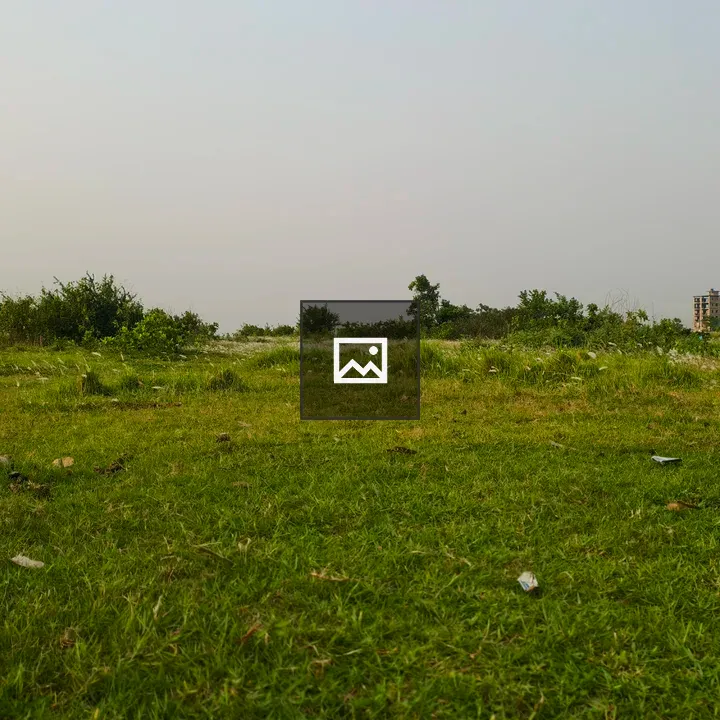 Green field with trees and building