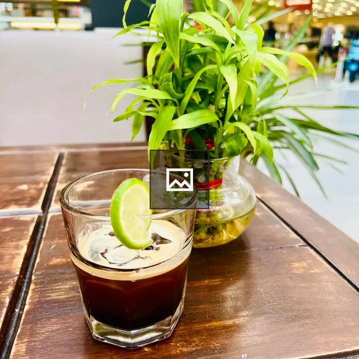 Iced coffee with lime on table