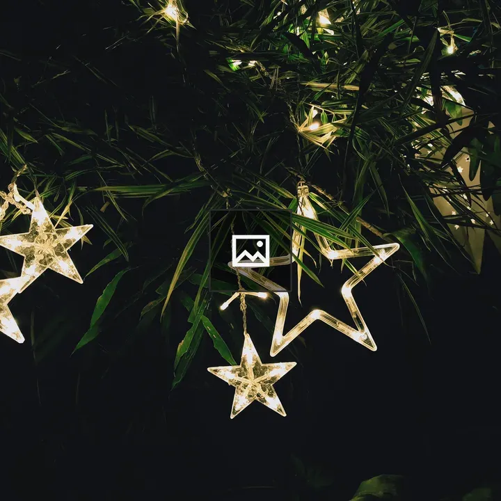 Night sky with stars over green lights