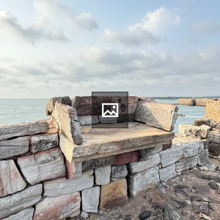 Stone bench on rocky shore