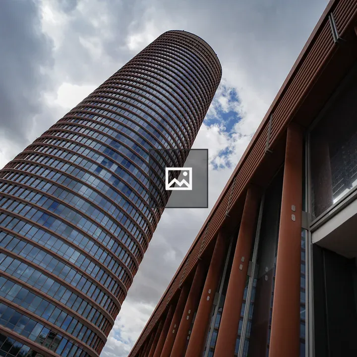 Modern cylindrical high-rise from below