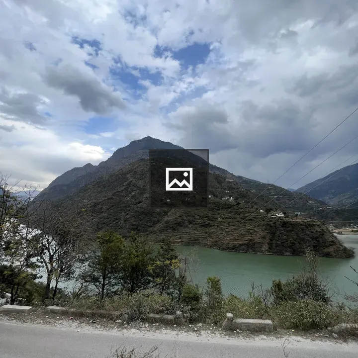 Mountain village by lake and road
