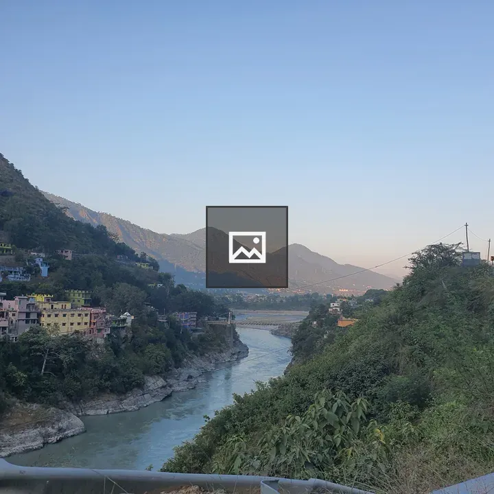 River Valley with Buildings and Mountains