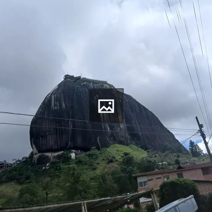 Rock Formation with Rural Backdrop