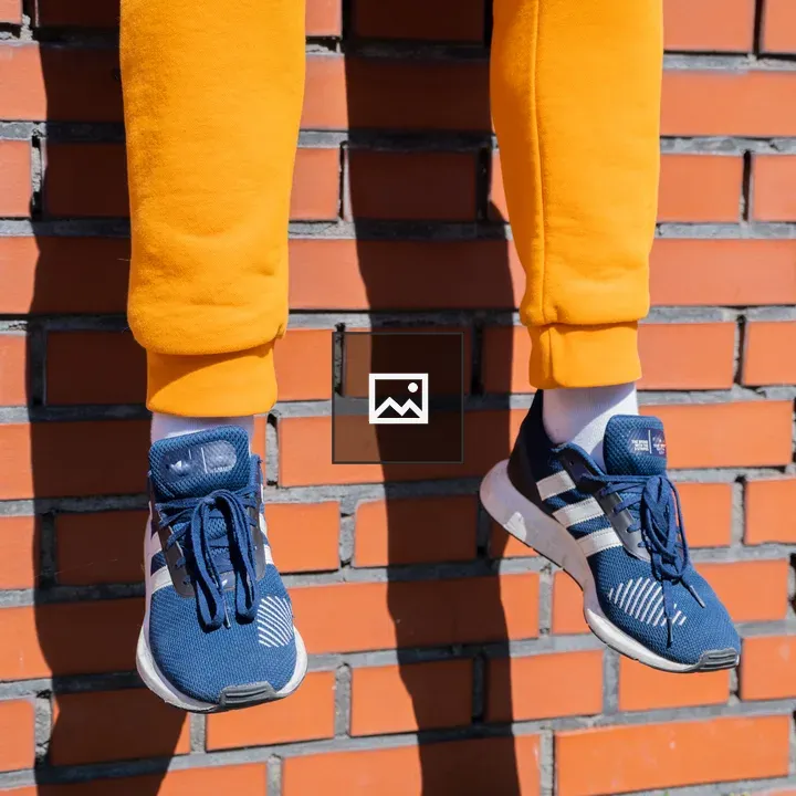 Casually dressed man on brick wall