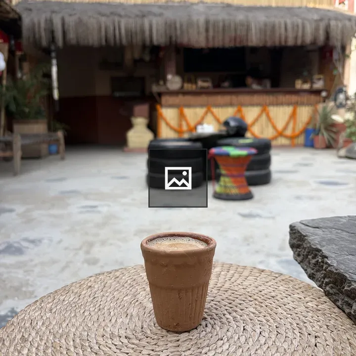 Cup of tea on table with building