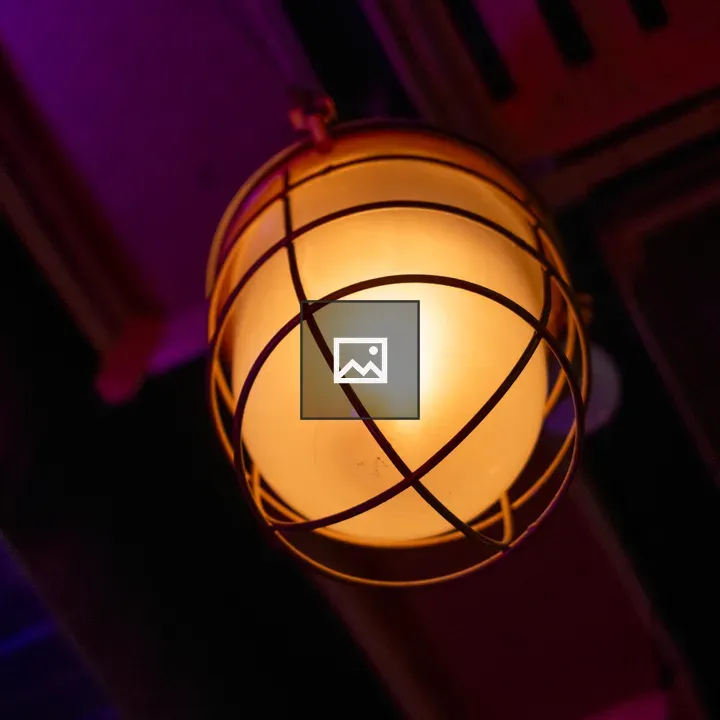 Old yellow lamp in ceiling lamp guard
