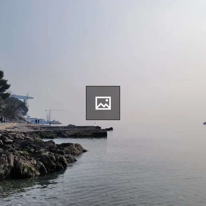 Foggy Adriatic shoreline with pier