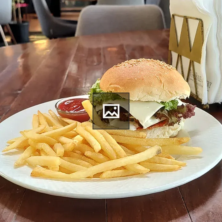 Burger and fries on wooden table