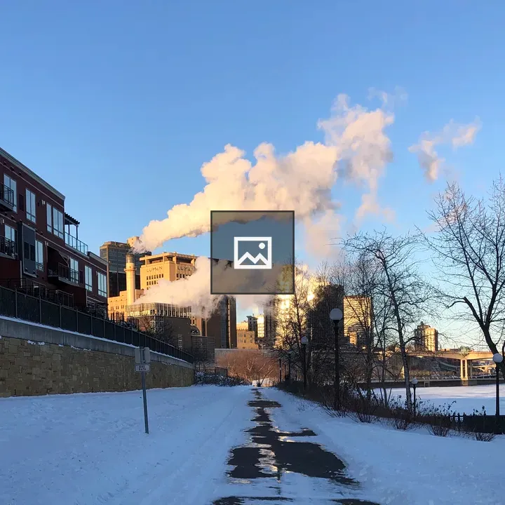 Cloud of furnace exhaust over city bridge