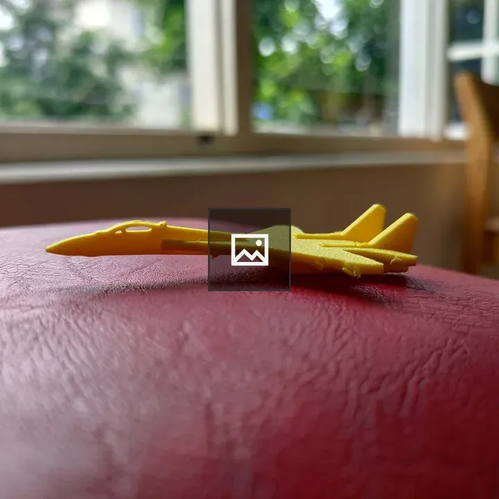 Yellow toy jet on red leather