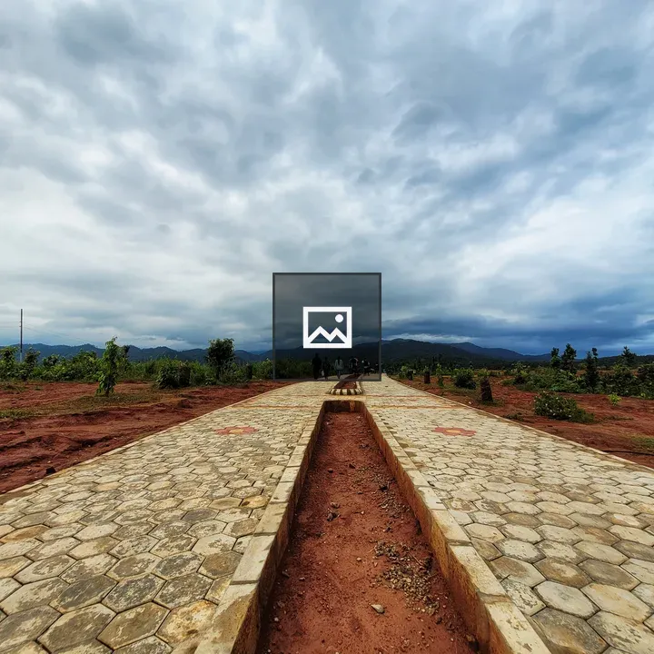 Paved Path with Trees and Clouds