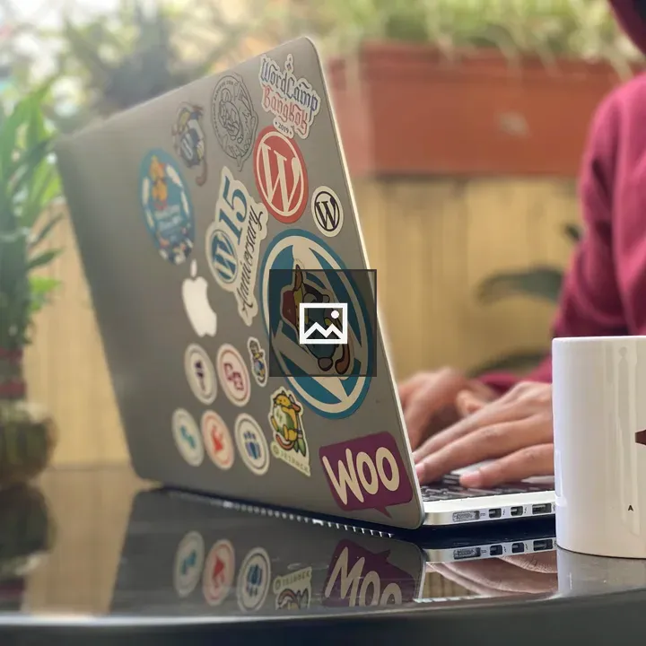 Man on Laptop with Colorful Stickers