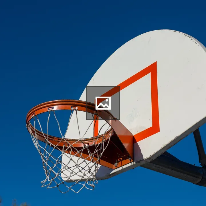 Outdoor basketball hoop against blue sky
