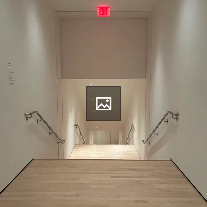 Wide staircase hallway with exit sign