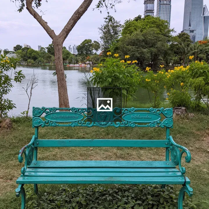 Turquoise bench by lake in Lumphini Park