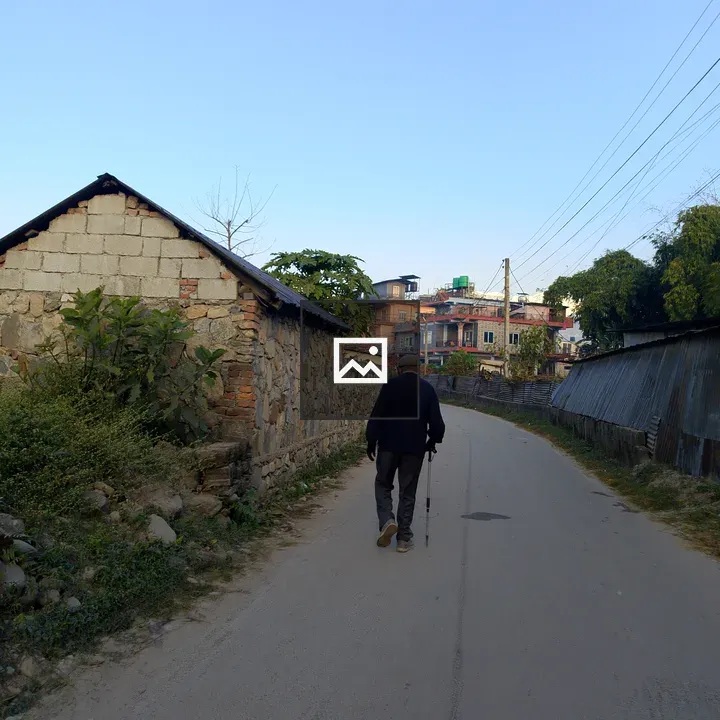 Person with Cane on Dirt Road
