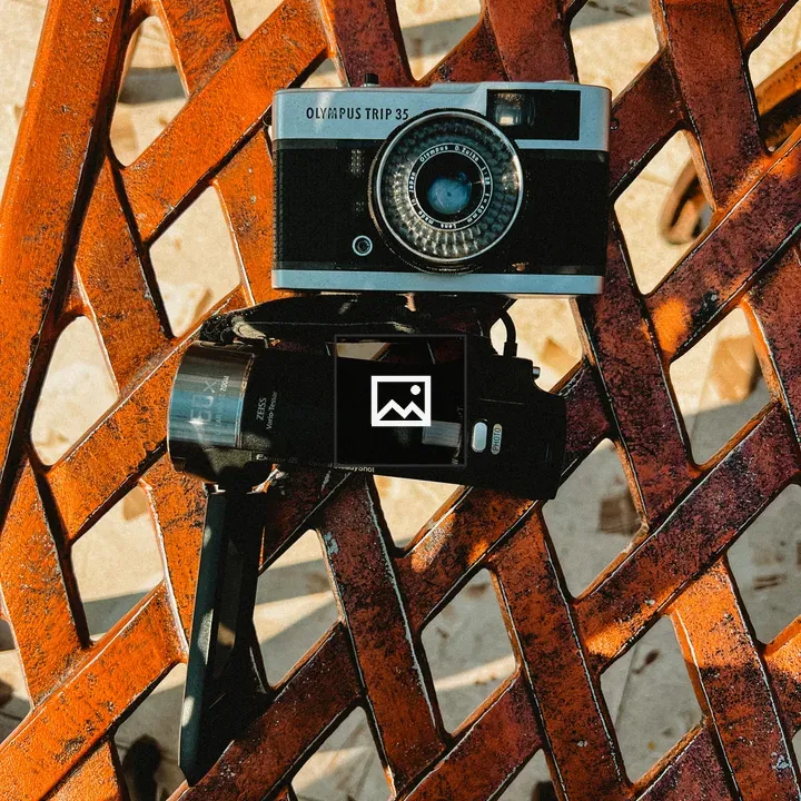Old analog camera on rusted surface