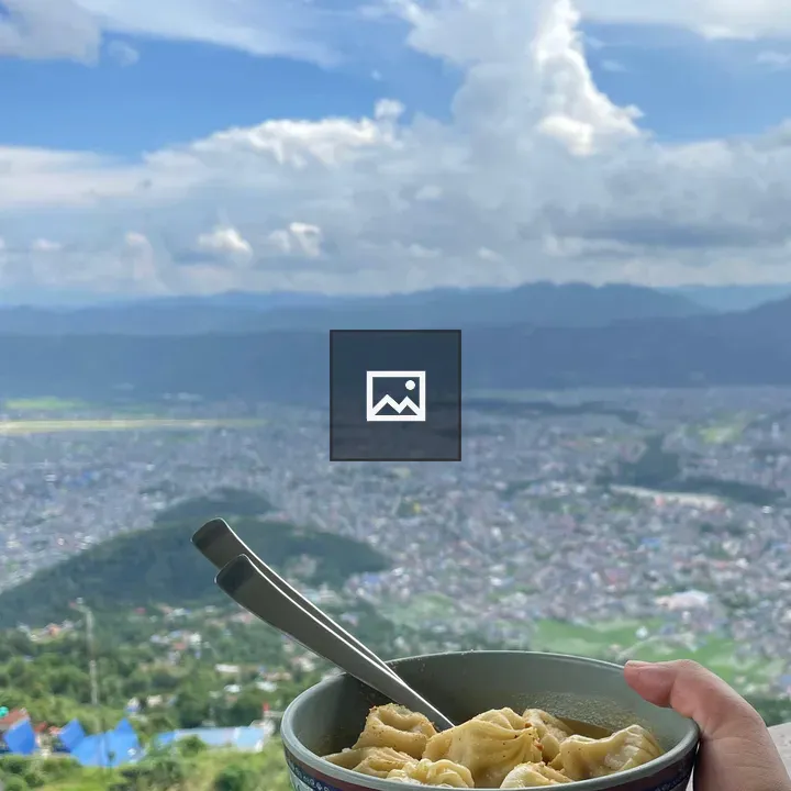 Hand holding dumpling bowl