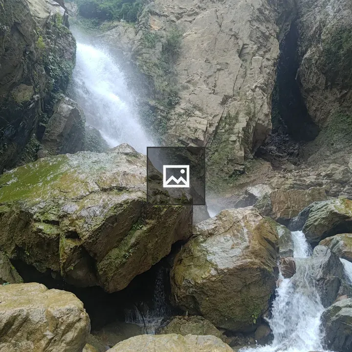 Waterfall over mossy rocks